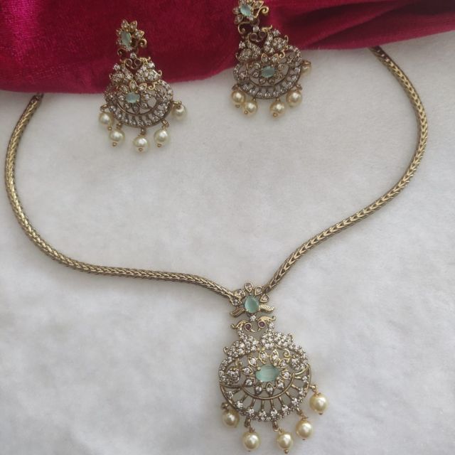 Antique Gold Finish American Diamond Necklace Set with Mint Stone & Pearl Drops